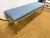 An elegant long upholstered bench with a carved giltwood frame, cabriole legs, and blue textured upholstery. Perfect as a...