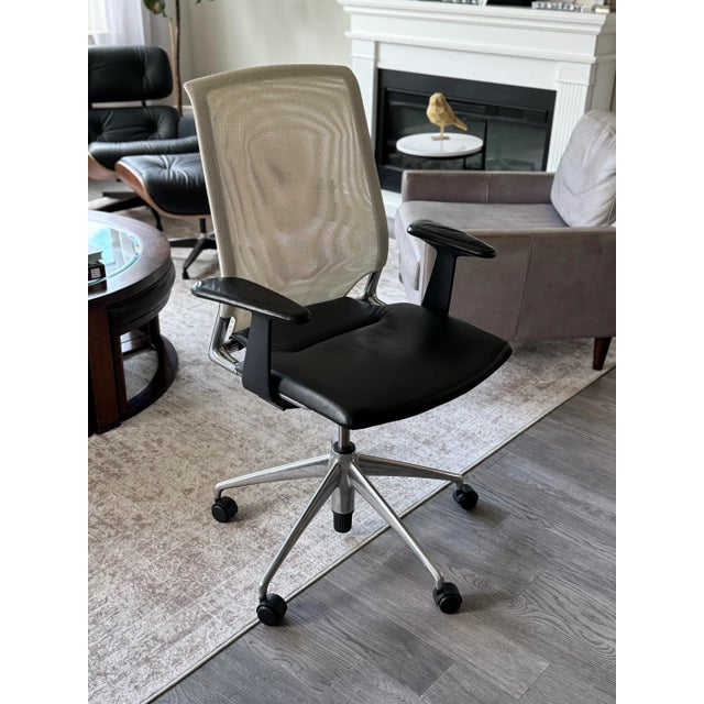 Vitra swivel leather chair designed by Alberto meda with polished aluminum base, leather seat, and mesh back. Height and...