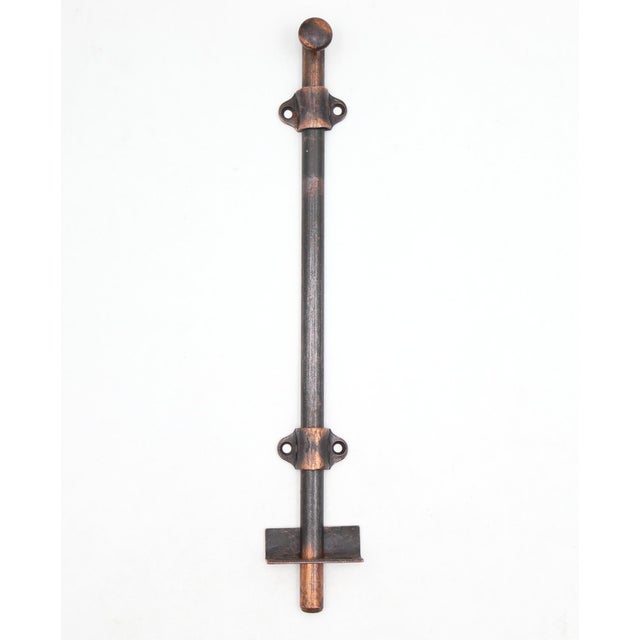 Vintage surface mount slide door bolt made of steel with a japanned finish. The original mounting screws are not...