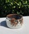 Vintage ceramic cat bowl featuring a sculpted cat face with expressive features and striking turquoise-green eyes. The...