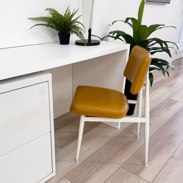 This authentic mid-century modern side chair features a classic beautifully-rich mustard viny! seat that practically glows...