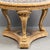 An exceptional entry or center table with a tessellated table top of marble varieties in a symmetrical geometric pattern....