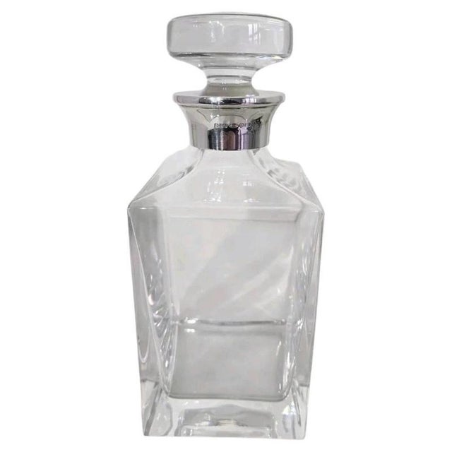 A fine vintage cut glass spirit decanter dating to 2001, combining a substantial clear glass body with an elegant sterling...