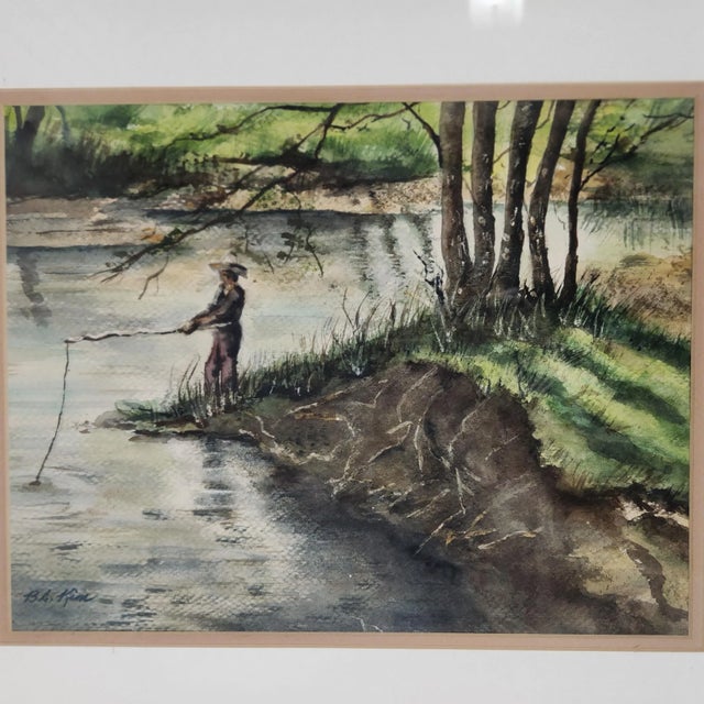 Tranquil and timeless, this original watercolor painting by B.A. Kim captures a solitary figure standing at the water’s...