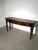 The table features three drawers, each decorated with geometric detailing and impressive brass lion-head ring pulls . Four...