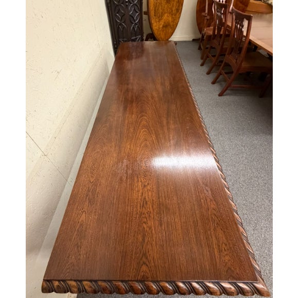 Regency style hand-carved console table in mahogany and walnut, circa 1980. The table features richly detailed carving...