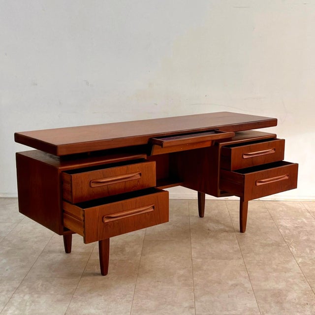 An elegant centerpiece desk, model "Fresco," designed by Victor Wilkins for British manufacturer G-Plan in the 1960s. This...