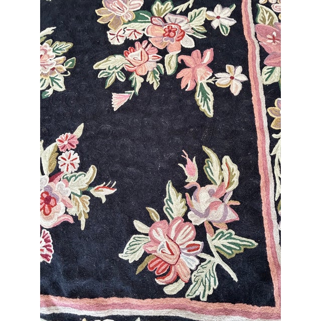 Romantic lovely area rug, hand made, with gorgeous groupings of light pink and green flowers against a black background....
