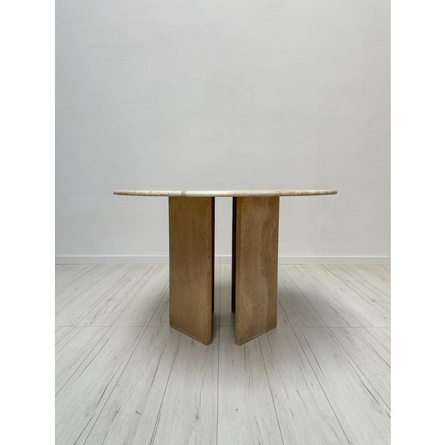 Unique vintage travertine dining table from the 1970s, showcasing a beautifully textured surface with a striking natural...