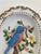 A delightful vintage porcelain wall plaque featuring a raised relief bird perched among flowering branches. The sculptural...