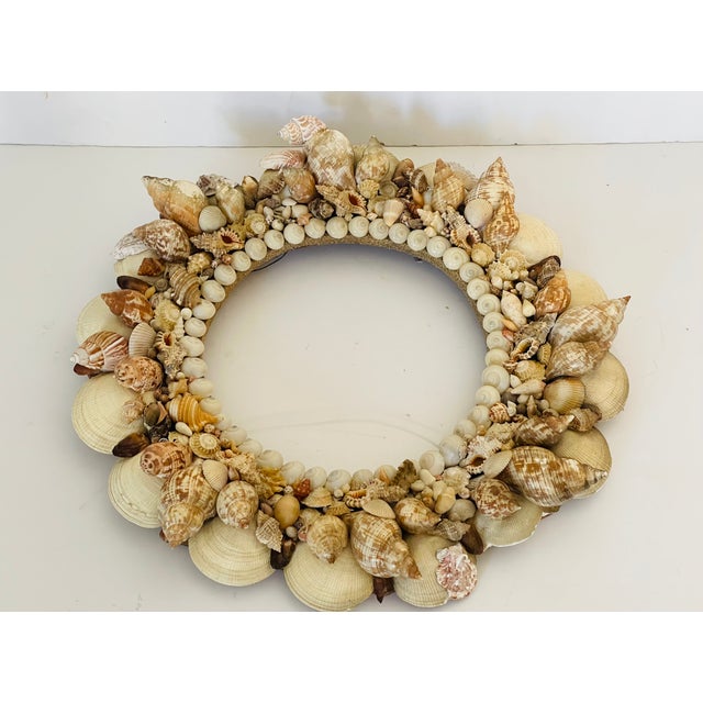 Antique sea Shell richly encrusted round mirror frame in distressed finish.