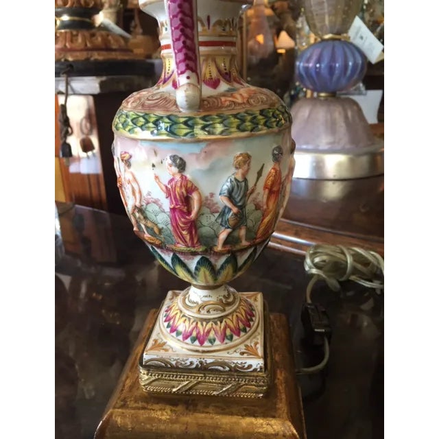 Pair of 19th c. Italian Capodimonte Porcelain Urns that have been converted to lamps. They are gilded and painted. The...