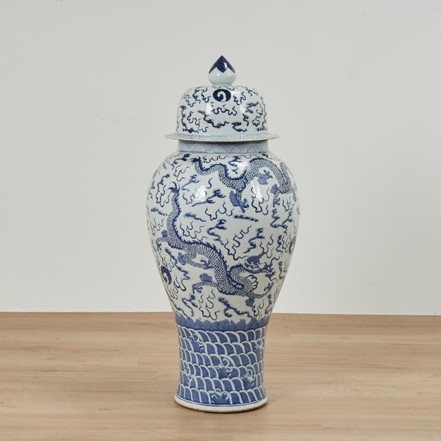 Impressive pair of Chinese blue and white porcelain palace urns featuring an elegant baluster form richly decorated with...