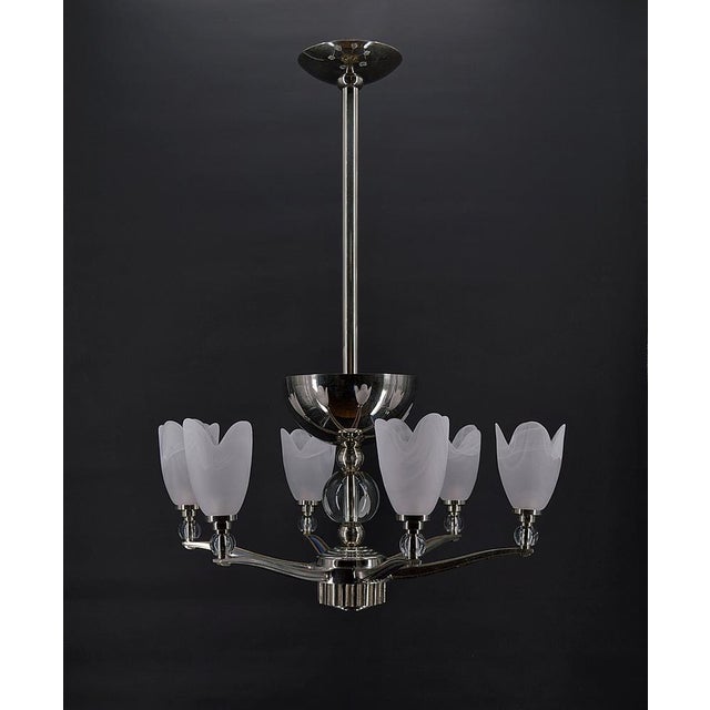 Elegant silver / chrome bronze chandelier composed of a ceiling diffuser with two lights, and 6 arms decorated with glass...