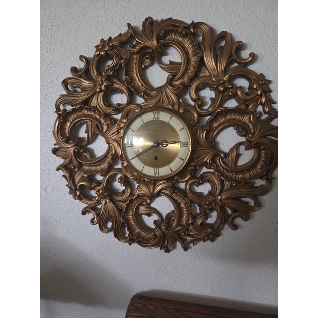 Add a striking statement piece to your interior with this exceptional mid-century Hollywood Regency wall clock. Circa...