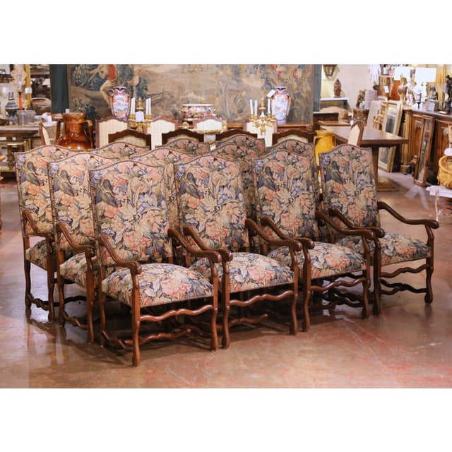 This impressive suite of twelve Louis XIII style dining armchairs was crafted circa 1980. The chairs reflect the bold,...
