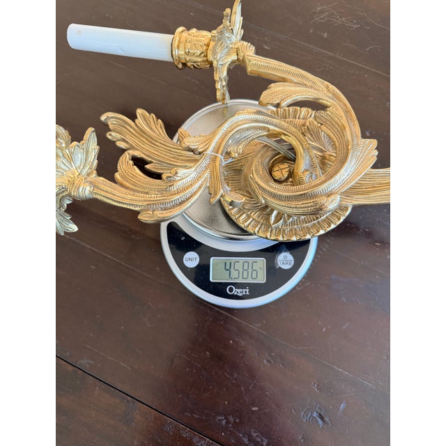 Elegant pair of vintage double-arm wall sconces in the Louis XV / Rococo revival style. Each features ornate acanthus leaf...