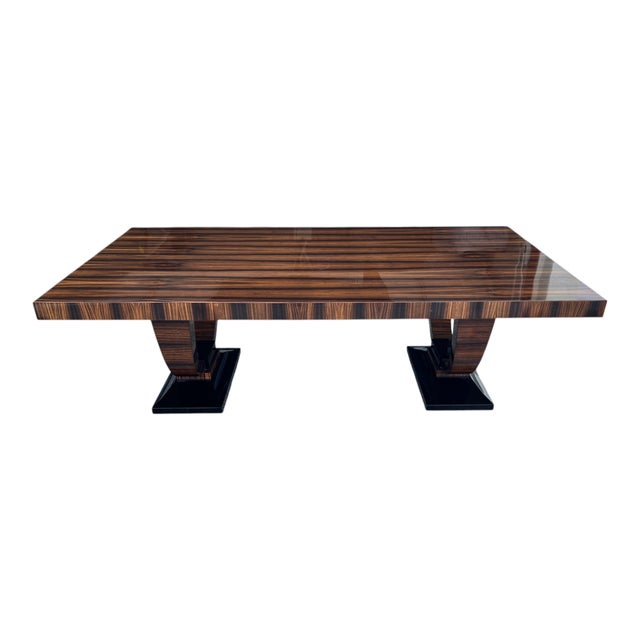 This exceptional large-scale executive dining table showcases the dramatic elegance of richly figured Macassar ebony...