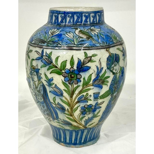 Beautiful Persian antique hand painted with figures, birds and flowers polychrome glazed earthenware vase. Late 19th-early...