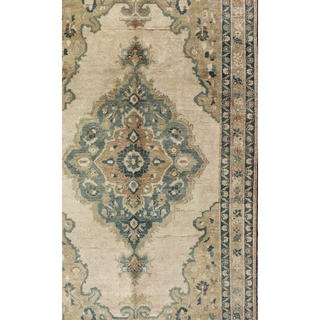 Muted Turkish Rug with Floral Design in Blue, Green, Light Taupe, Ivory & Cream Measures: 5'2 x 9'11. This vintage Turkish...