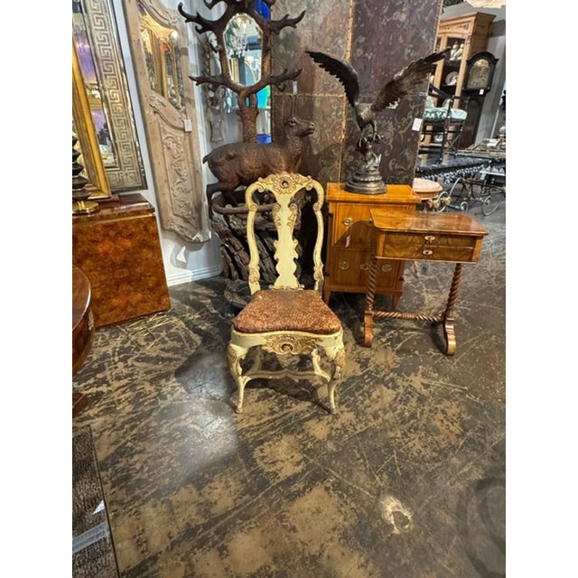 The 18th c. Italian Baroque Parcel Gilt Side Chair is a luxurious and elegant piece of furniture. Its intricate parcel...