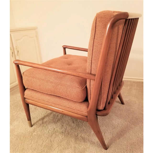 Rare walnut lounge chair by J S Clingman for Widdicomb circa 1960. Features dowel rod back, turned arms, and brass sabots....