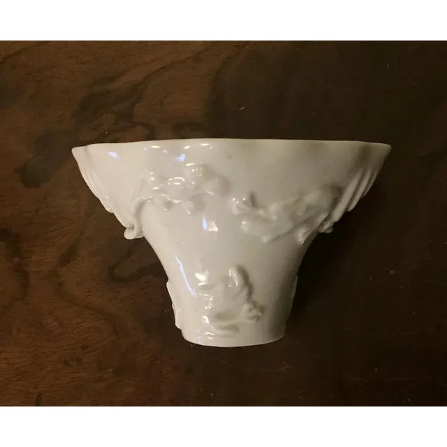 Antique 19th c. Chinese white porcelain libation cup decorated with deer and mythical beasts. Measures 4" x 3" x 2 1/2"...