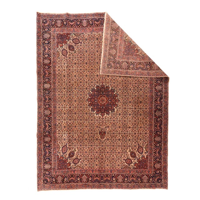 This modern west Persian Kurdish town carpet shows a cream field in a close allover Herati design overlaid by a variant of...