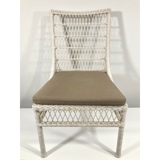 This woven resin wicker side chair was designed by Eric Homan as part of the Water Mill Kitchen Collection for McGuire of...