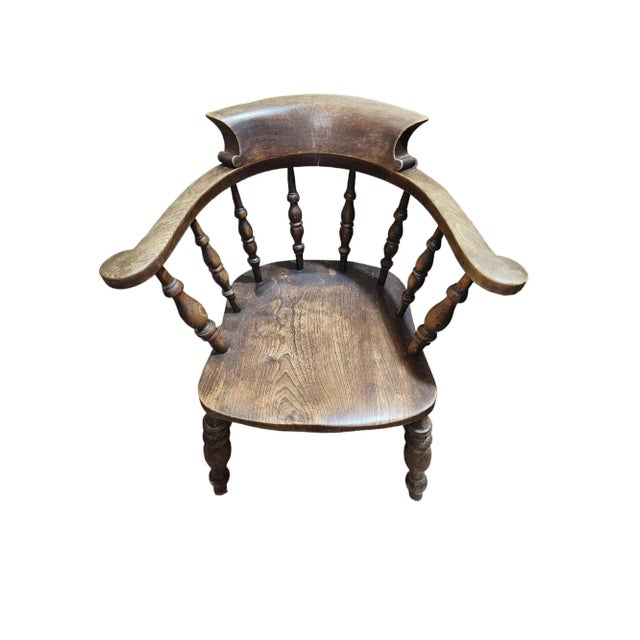 Fantastic example of an English solid oak smokers bow armchair, made by important English furniture manufacturer Joynson...