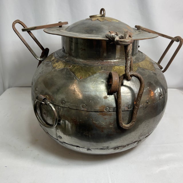 This 19th-century antique Indian iron lidded water vessel is a charming find for those who appreciate the fusion of...