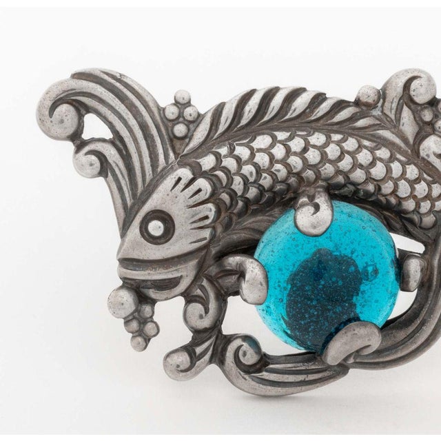 Los Castillo Sterling Silver Aquatic Motif Pin, designed as a fish decorated with one prong set round blue glass cabochon...