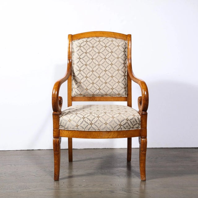 This elegant and sculptural pair of Biedermeier arm chairs were realized in Austria circa 1880. Realized in a stunning...