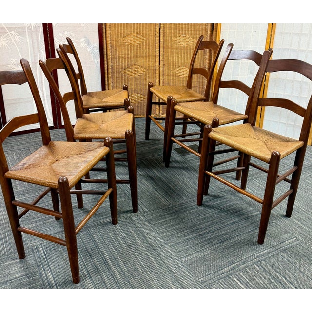 Set of six solid walnut ladder back chairs. Perfectly intact rush seats. Excellent vintage condition. 34”tall, 19”wide and...