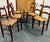 Set of six solid walnut ladder back chairs. Perfectly intact rush seats. Excellent vintage condition. 34”tall, 19”wide and...