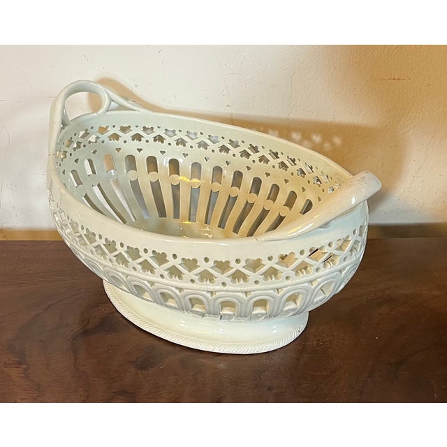 Antique 18th century George III Shorthose creamware basket with intricate pierced sides and loop handles. Measures 10 3/8"...
