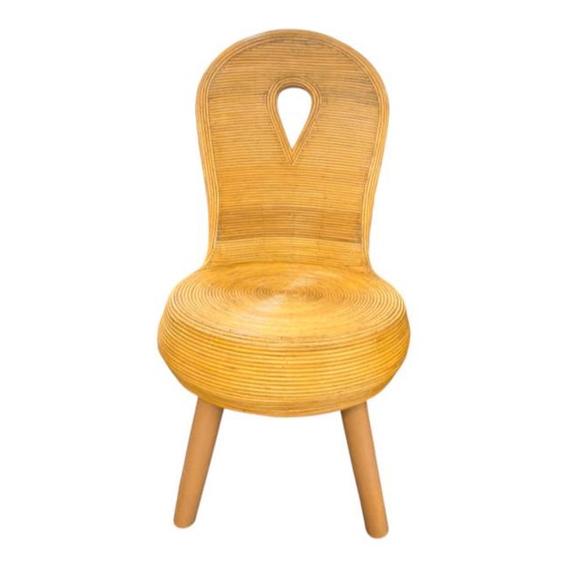 Striking vintage sculptural side chair crafted entirely from pencil reed, featuring a beautifully rounded silhouette and...