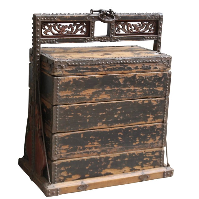 This exotic looking box is a wood container with 4 separate compartments, used to transfer the dishes by the restaurant....