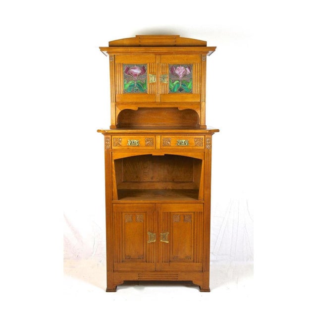 Charming oakwood Art Nouveau cabinet or buffet originating from period in Austria around 1910. Consisting of two parts,...