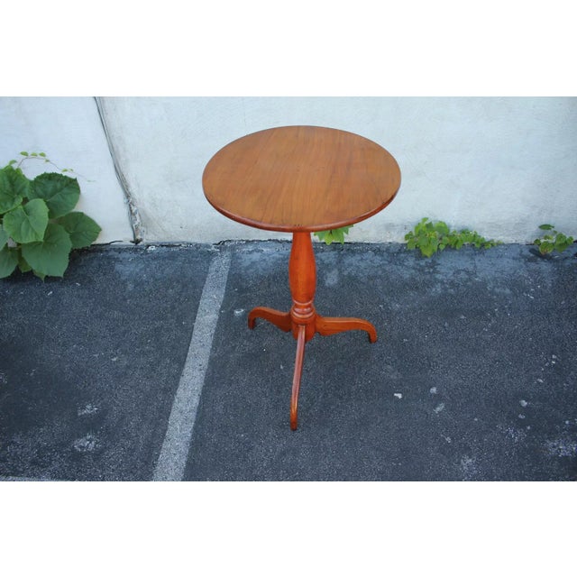 Lovely Colonial style stand, side table, c. 19th, featuring a round top over a turned column ending in a tripod base. It...