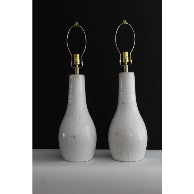 A beautiful pair of Christian Dior style lamps. Rustic white glaze overlay on terracotta. Graceful and simple in style...