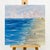 This hand-painted seascape captures the tranquility of the ocean, featuring soft waves and a serene shoreline. The view...