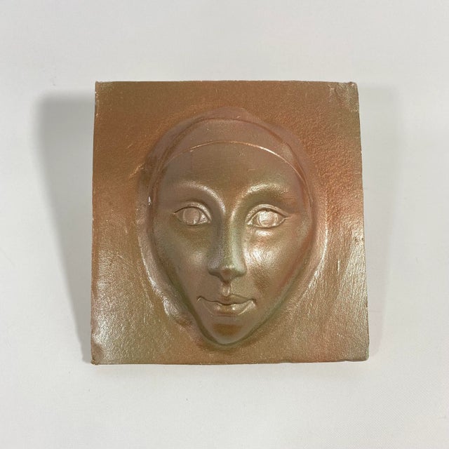 Studio pottery circa 1990s wall sculpture of a face. Glazed with metallic gold tones and slight iridescent green...