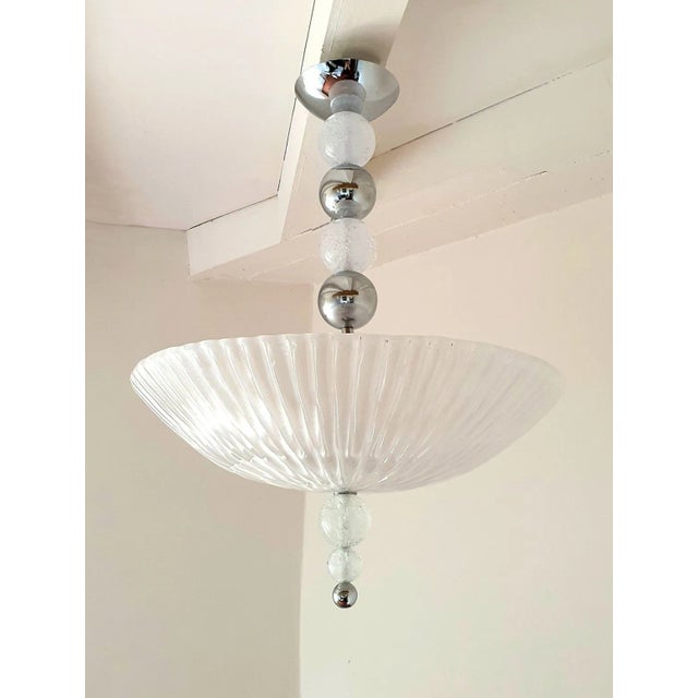 Mid-Century Modern Murano glass and chrome chandelier, attributed to Barovier and Toso, Italy 1970s. The vintage Modern...