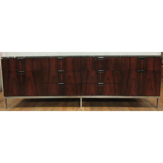This is a beautiful and rare vintage rosewood credenza with a marble top, designed by Florence Knoll for Knoll...