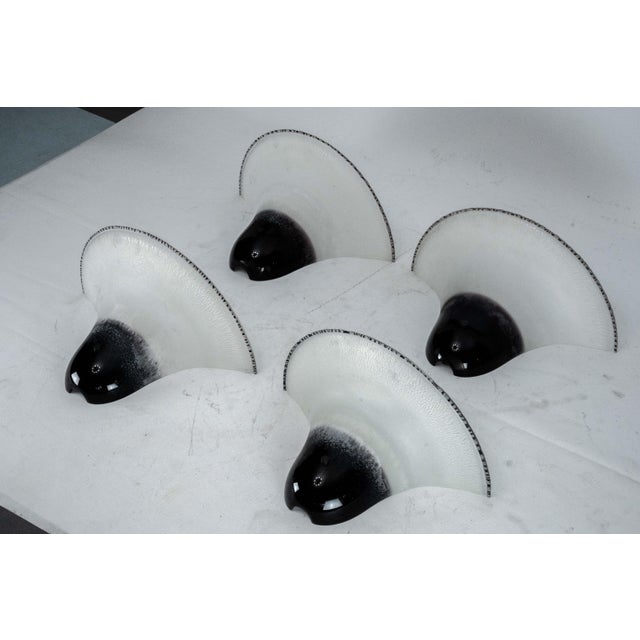 A striking set of four large vintage wall sconces hand-blown in fine murano glass during the 1970s. Signed by barbini,...