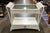 Charming off white wicker console table featuring a woven frame and glass top. Its light, airy design adds texture and...