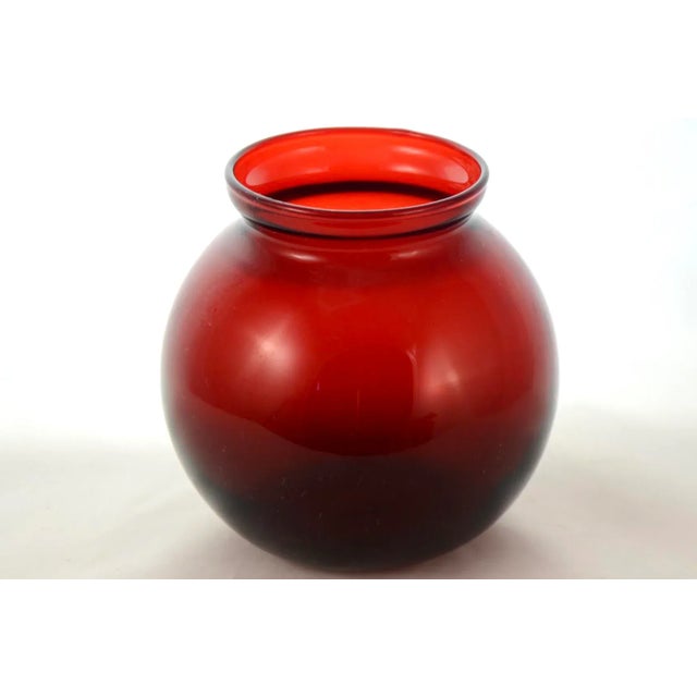 Ruby red four inch vintage glass ball vase or catchall with a slightly flared rim. Simply a beautiful vintage addition to...