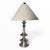 A pair of beautiful sculptural table lamps with a patinated silver finish. White linen conical shades and matching...