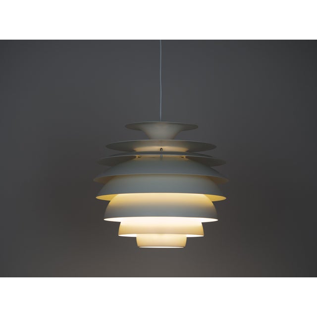 The Barcelona lamp by Bent Karlby is an elegant 1960s ceiling lamp made of aluminum. It features a minimalist, geometric...